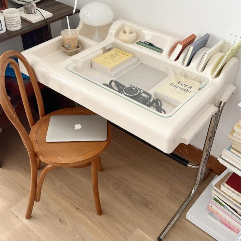 White vanity desk styled with books, plant, drink and laptop in a home office